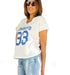 White V-neck t-shirt with blue print '33', worn by a woman with sunglasses, styled for a casual outfit.